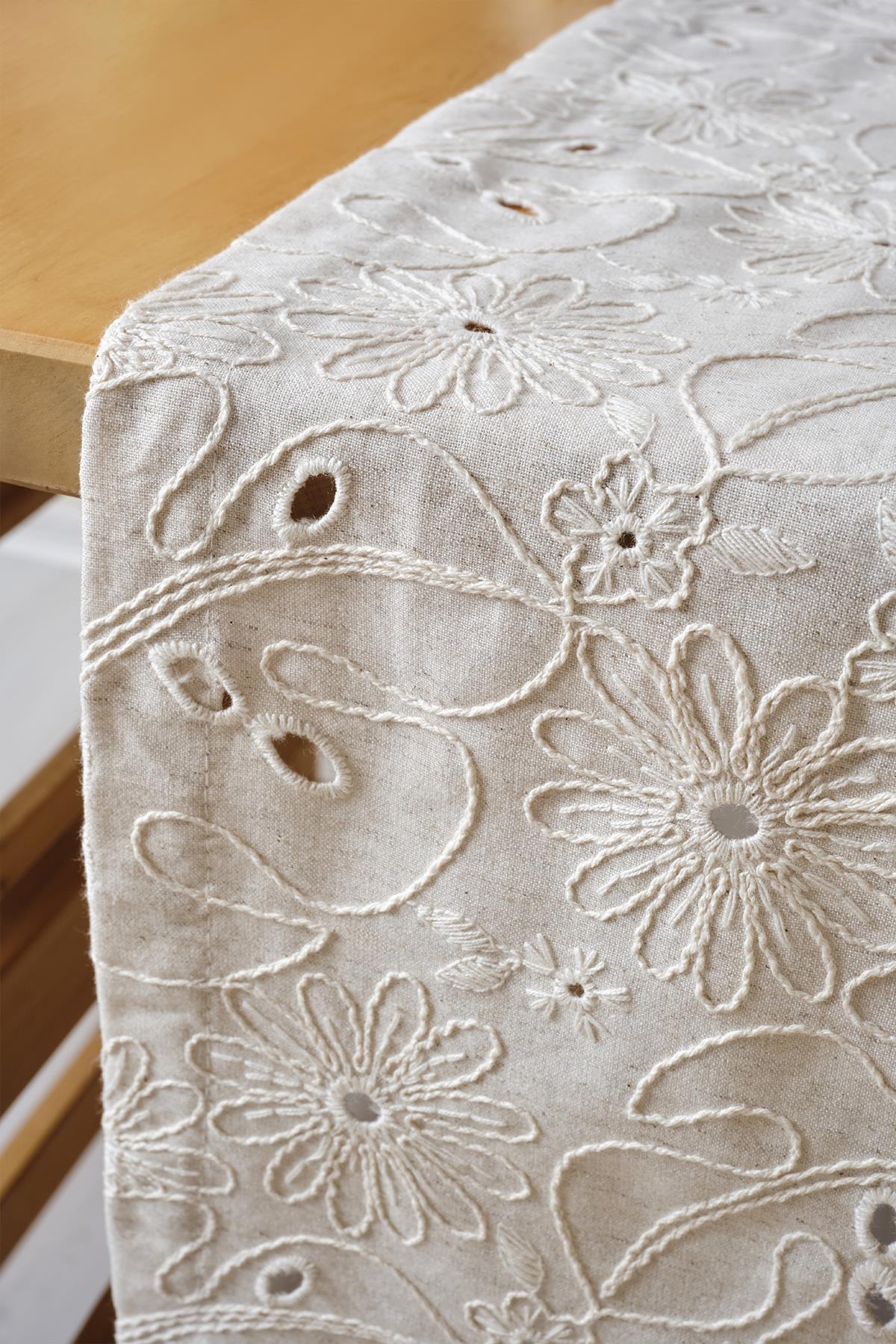 Tovaglia color crema con pizzo, runner ricamato con motivo floreale